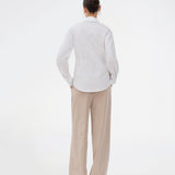 A modern interpretation of the classic shirt in white. The UllisMD Shirt is made from 97% organic cotton and designed with a pointed collar, half button closure, and a feminine, fitted silhouette that creates an elegant and sophisticated look. The model is 175 cm and wears a size S/36.

Material:
97% Organic Cotton
3% Elastane
