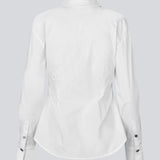 A modern interpretation of the classic shirt in white. The UllisMD Shirt is made from 97% organic cotton and designed with a pointed collar, half button closure, and a feminine, fitted silhouette that creates an elegant and sophisticated look. The model is 175 cm and wears a size S/36.

Material:
97% Organic Cotton
3% Elastane