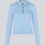 Elegant knitted blouse in light blue with contrast stitching. The UrdMD LS Top is made from 100% organic cotton and features a collar, long sleeves, and button detailing. A timeless and feminine choice for any occasion. The model is 175 cm and wears a size S/36.

Material:
95% Organic Cotton
5% Elastane
