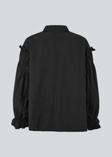 Feminine black shirt with smock and ruffle details. The UlfurMD Shirt features tonal stripes, a collar, button closure, and voluminous sleeves with smock and ruffles – an elegant and modern shirt that adds a sophisticated touch to both everyday and work looks. The model is 175 cm and wears a size S/36.


Material:
40% Cotton
60% Recycled Polyester
