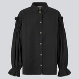 Feminine black shirt with smock and ruffle details. The UlfurMD Shirt features tonal stripes, a collar, button closure, and voluminous sleeves with smock and ruffles – an elegant and modern shirt that adds a sophisticated touch to both everyday and work looks. The model is 175 cm and wears a size S/36.


Material:
40% Cotton
60% Recycled Polyester
