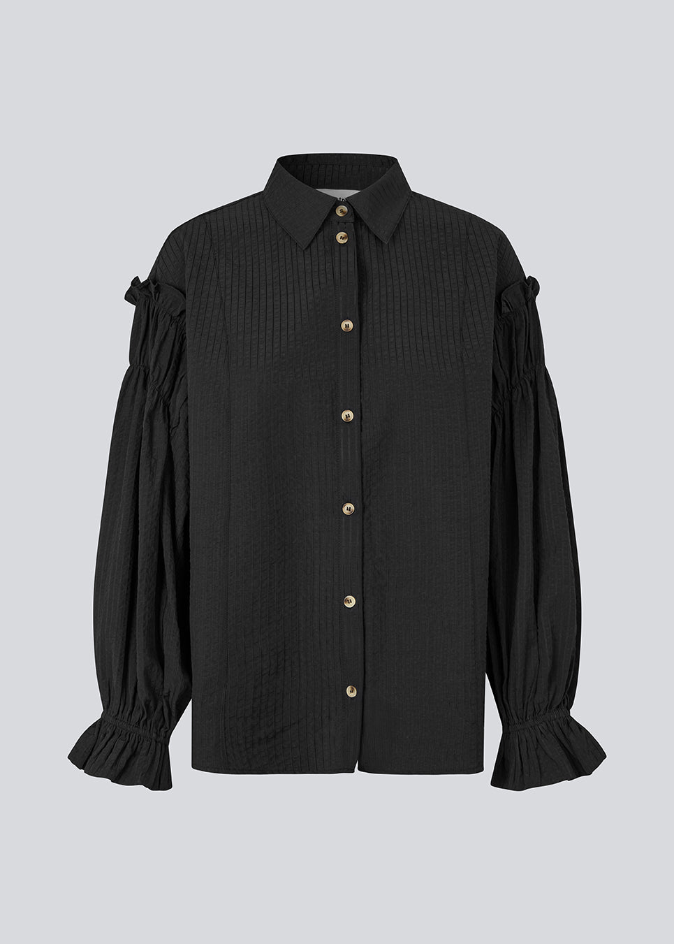 Feminine black shirt with smock and ruffle details. The UlfurMD Shirt features tonal stripes, a collar, button closure, and voluminous sleeves with smock and ruffles – an elegant and modern shirt that adds a sophisticated touch to both everyday and work looks. The model is 175 cm and wears a size S/36.


Material:
40% Cotton
60% Recycled Polyester