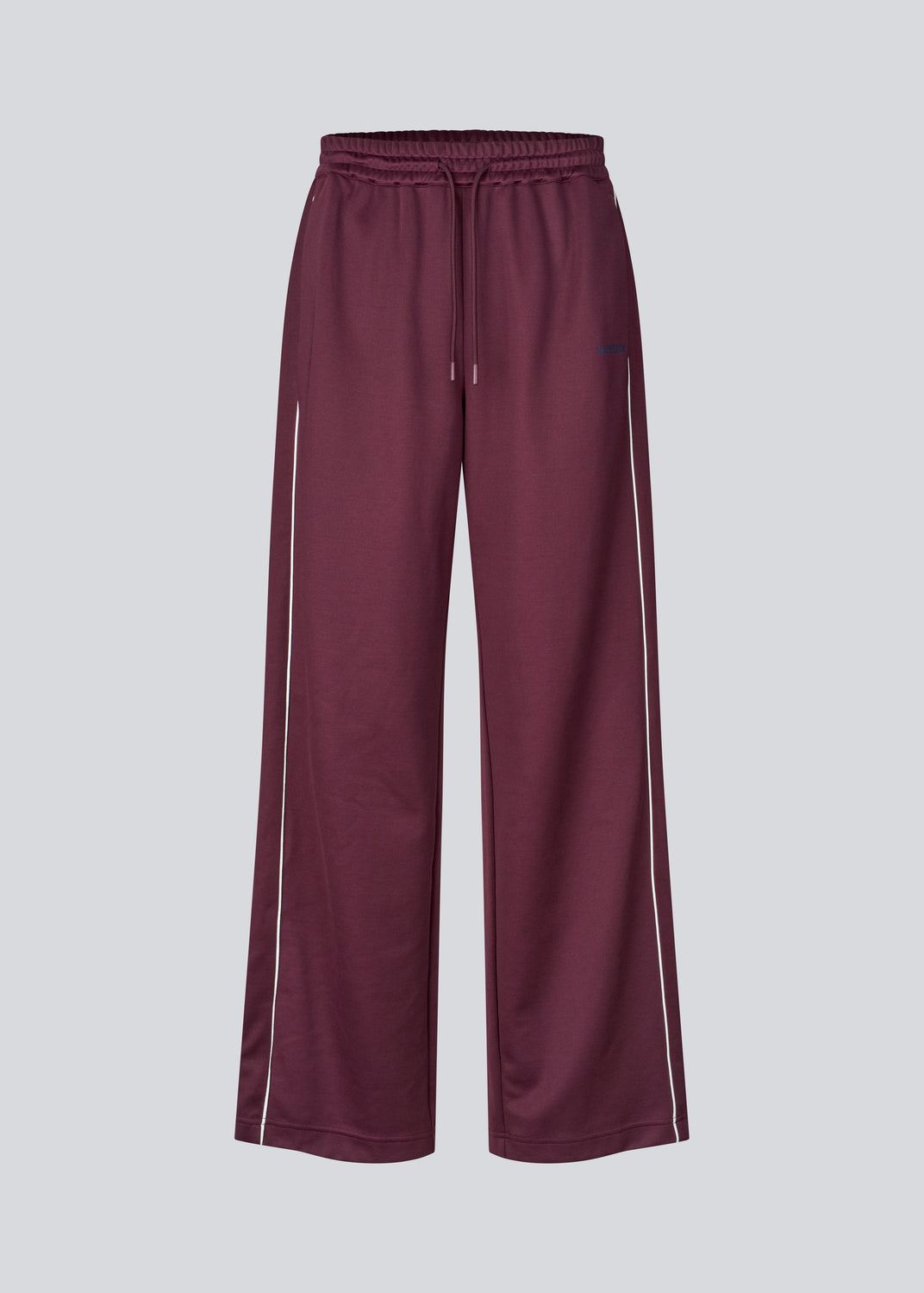 Dark red tracksuitpants with wide legs in 100% recycled polyester. Utopiamd pants has sidepockets, logo and an elastic waistband with tiebands.