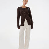 Timeless rib-knit cardigan in brown with a round neckline and front button closure. The UvisMD Cardigan features a fitted silhouette and a soft quality that gives it a feminine and elegant look. Perfect for everyday wear and layering through the seasons. The model is 175 cm and wears a size S/36.

Material:
100% Organic Cotton