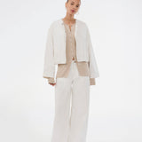 Timeless rib-knit cardigan in beige with a round neckline and front button closure. The UvisMD Cardigan features a fitted silhouette and a soft quality that gives it a feminine and elegant look. Perfect for everyday wear and layering through the seasons. The model is 175 cm and wears a size S/36.



Material:
100% Organic Cotton