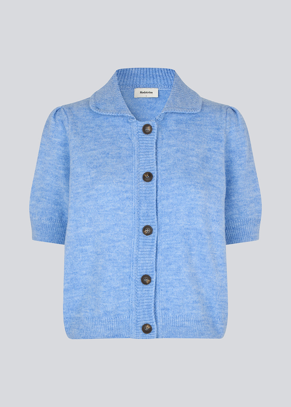 Short-sleeved light blue cardigan with a collar. The UzziMD Cardigan features a contrasting button closure and delicate ribbed trims, creating an elegant and sophisticated look. Can be worn both open and closed. The model is 175 cm and wears a size S/36.


Material:
76% Acrylic
24% Polyester