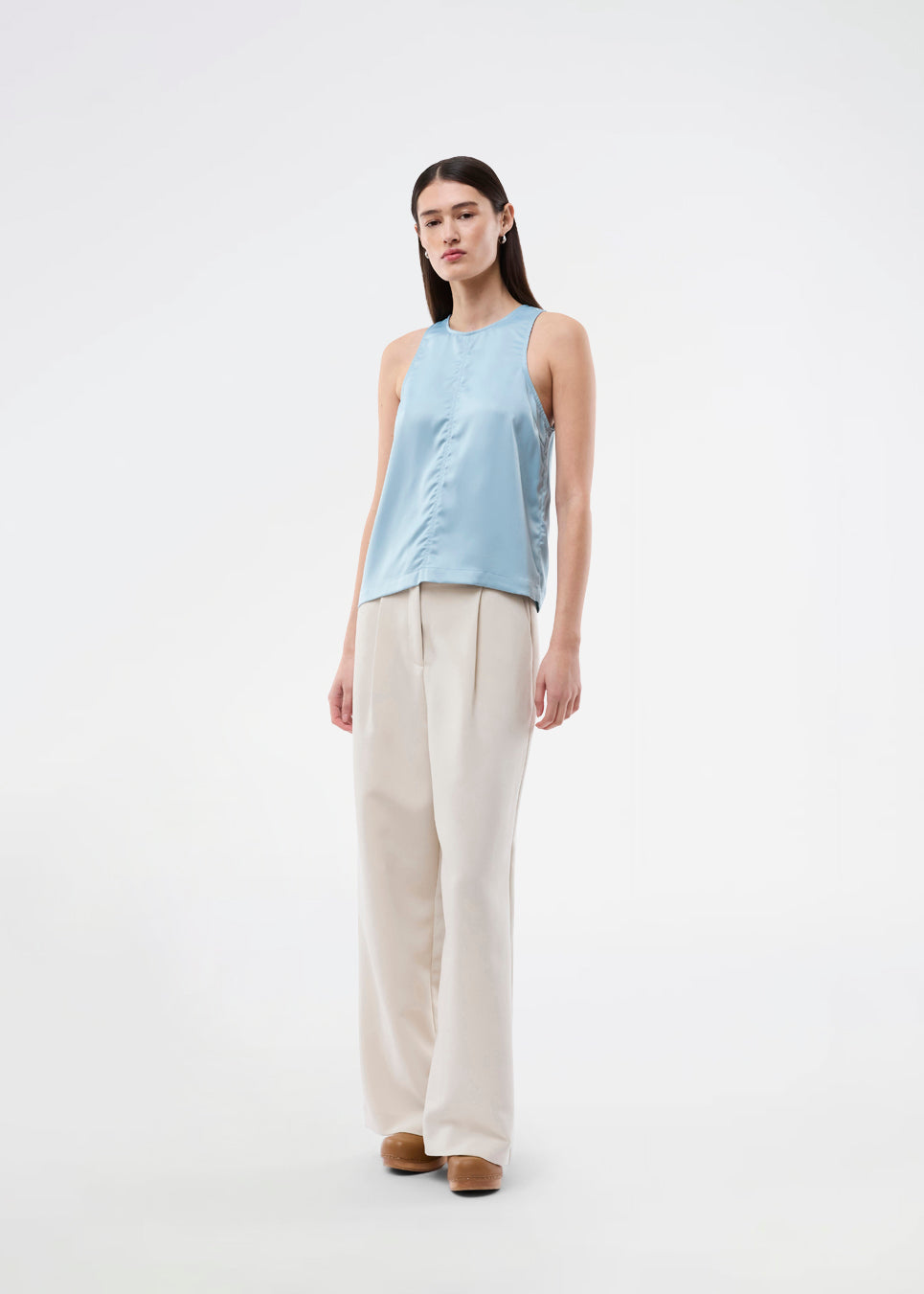 Sleeveless top in blue in lustrous satin. The Valdomd Top features a round neckline, vertical stitching detail at the front, and a button closure at the back for an elegant look. Made from 98% recycled polyester&nbsp;
