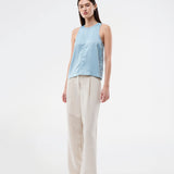 Sleeveless top in blue in lustrous satin. The Valdomd Top features a round neckline, vertical stitching detail at the front, and a button closure at the back for an elegant look. Made from 98% recycled polyester&nbsp;