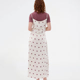 Long white satin dress with polka dots. The Vanjamd Print Dress features delicate spaghetti straps, a cowl neckline, and a loose, elegant drape that creates a feminine and modern look.