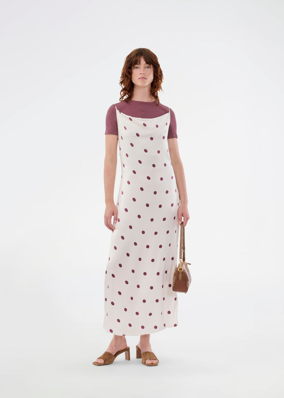 Long white satin dress with polka dots. The Vanjamd Print Dress features delicate spaghetti straps, a cowl neckline, and a loose, elegant drape that creates a feminine and modern look.