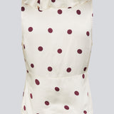 Polka-dotted sleeveless top with a ruffle trim. The Vanjamd Print Top is made from lustrous satin and features feminine details such as a V-neckline, ruching, and a tie detail under the bust for an elegant look.