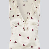 Polka-dotted sleeveless top with a ruffle trim. The Vanjamd Print Top is made from lustrous satin and features feminine details such as a V-neckline, ruching, and a tie detail under the bust for an elegant look.