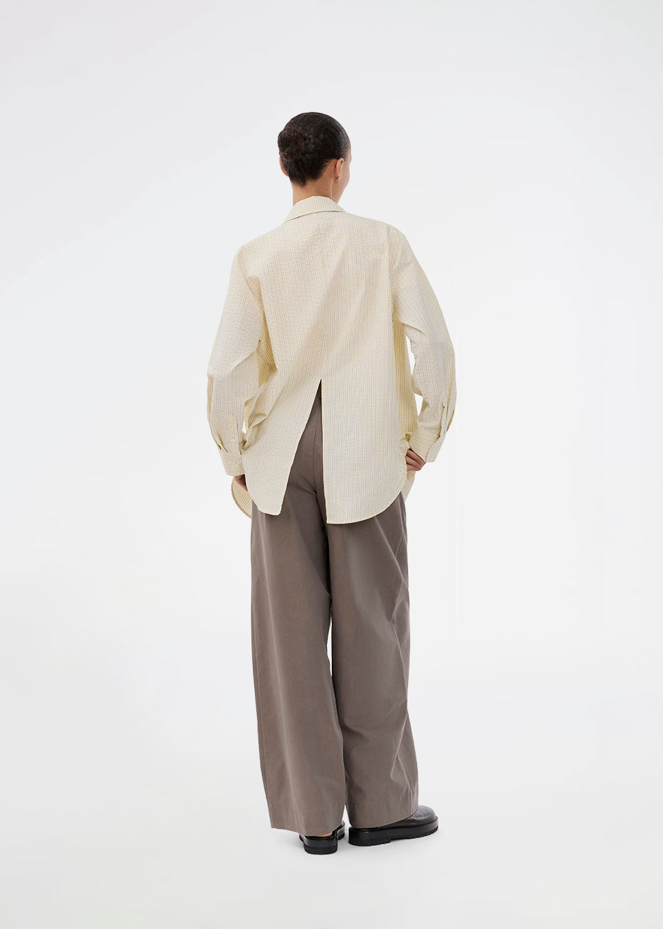 Long, classic striped shirt in light yellow. The ViggeMD Stripe Shirt features timeless details such as a collar, button closure, and cuffs, along with a high slit at the back that adds a modern twist to the otherwise simple design.&nbsp;
