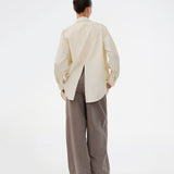 Long, classic striped shirt in light yellow. The ViggeMD Stripe Shirt features timeless details such as a collar, button closure, and cuffs, along with a high slit at the back that adds a modern twist to the otherwise simple design.&nbsp;
