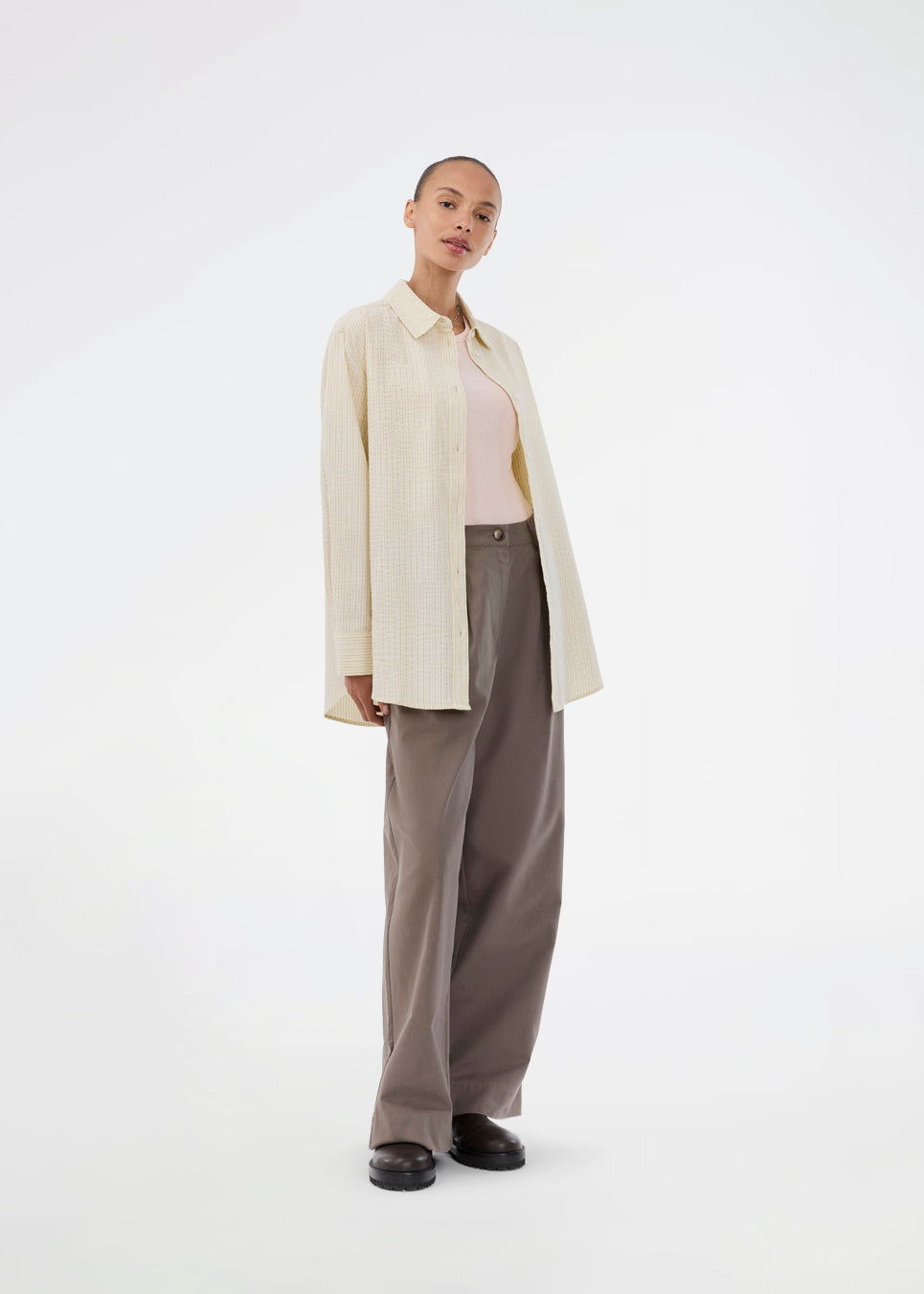 Long, classic striped shirt in light yellow. The ViggeMD Stripe Shirt features timeless details such as a collar, button closure, and cuffs, along with a high slit at the back that adds a modern twist to the otherwise simple design.&nbsp;
