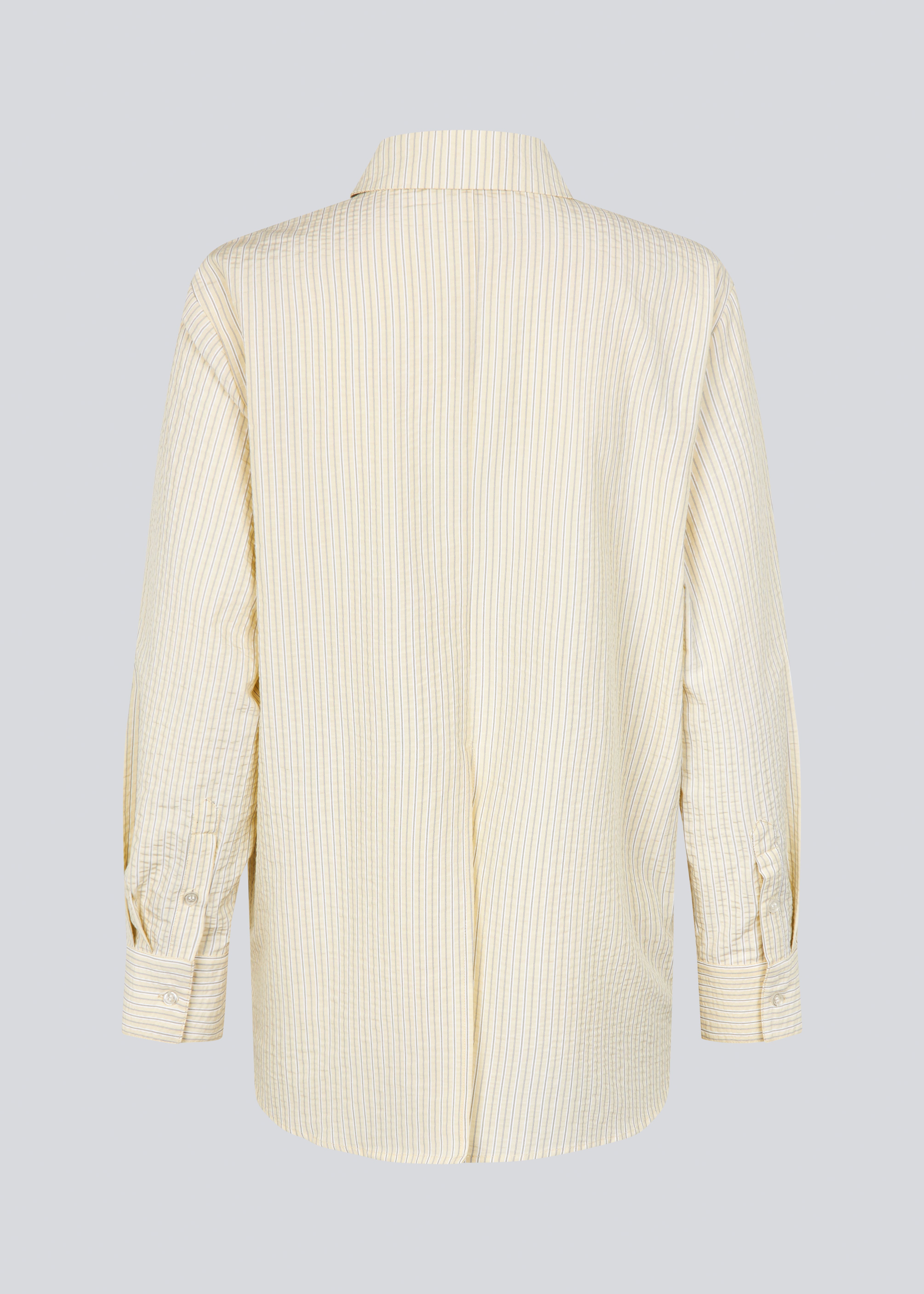 Long, classic striped shirt in light yellow. The ViggeMD Stripe Shirt features timeless details such as a collar, button closure, and cuffs, along with a high slit at the back that adds a modern twist to the otherwise simple design.&nbsp;

