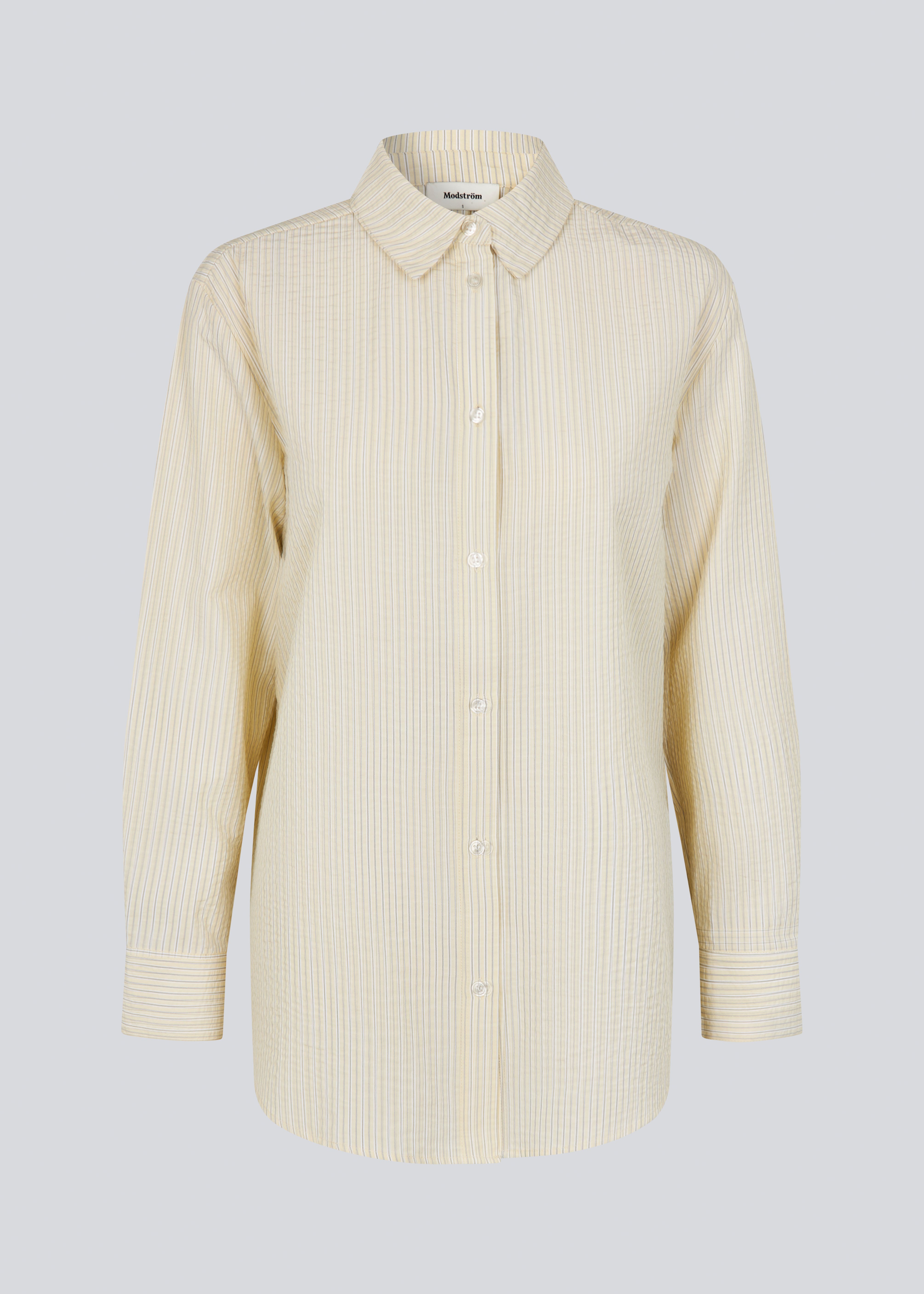 Long, classic striped shirt in light yellow. The ViggeMD Stripe Shirt features timeless details such as a collar, button closure, and cuffs, along with a high slit at the back that adds a modern twist to the otherwise simple design.&nbsp;
