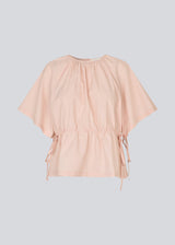 Vilbertmd top is designed with soft pleats at the neckline, short wide sleeves, and a side tie detail that creates a relaxed yet refined look. An elegant style that can easily be dressed up or down in the modern wardrobe.