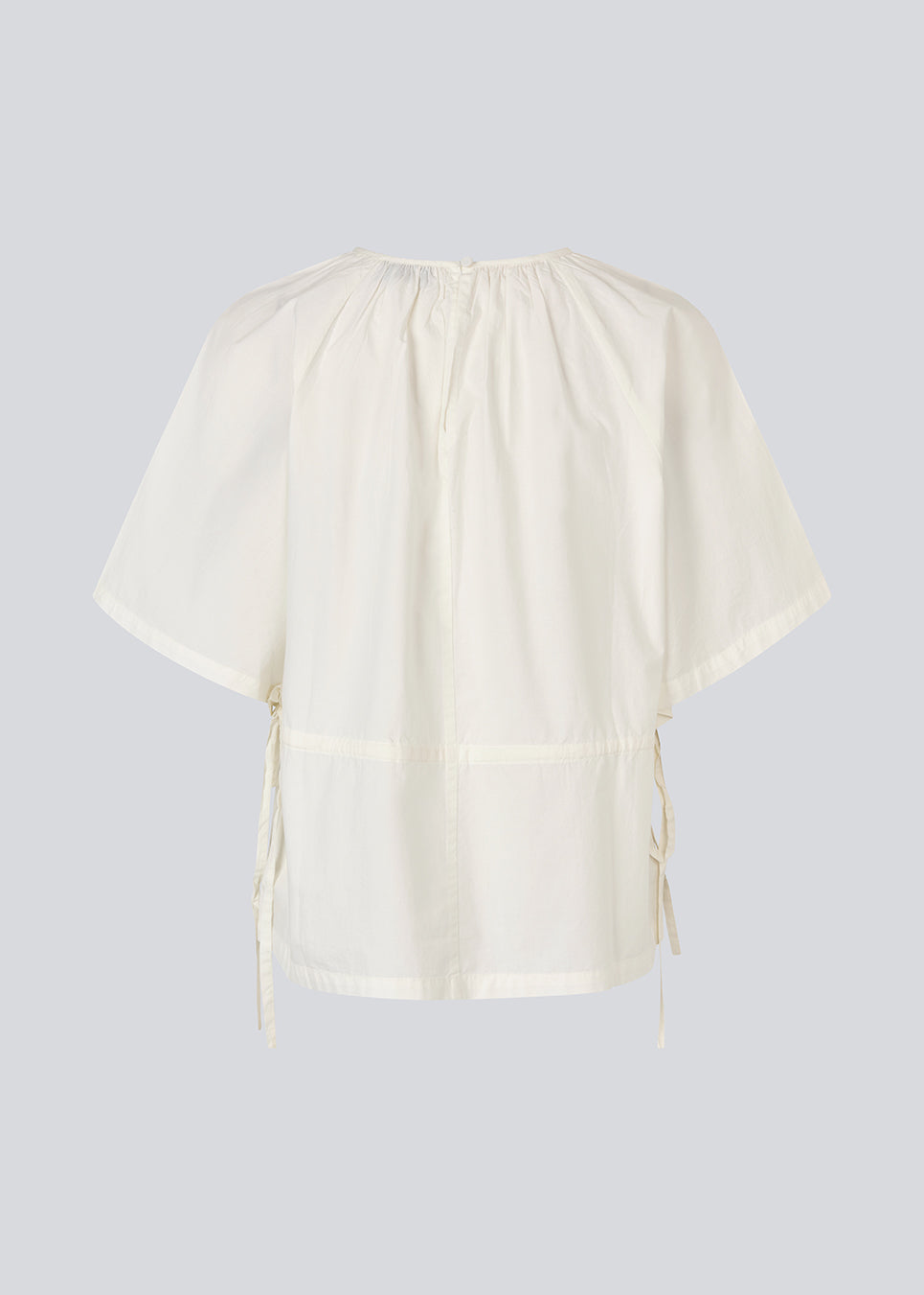 Vilbertmd top is designed with soft pleats at the neckline, short wide sleeves, and a side tie detail that creates a relaxed yet refined look. An elegant style that can easily be dressed up or down in the modern wardrobe.