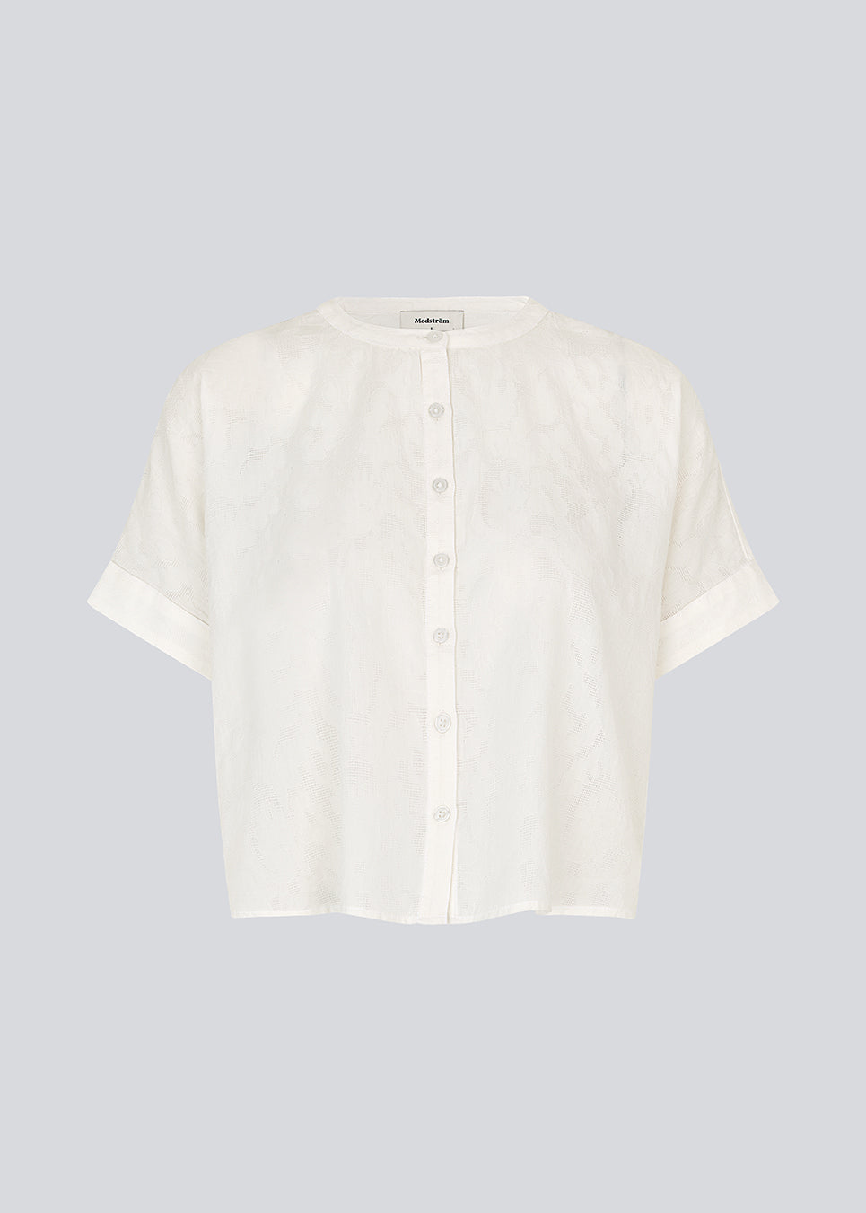 Short-sleeved shirt-blouse with a solid-color print. The VilleminMD shirt features a button closure, round neckline, and rolled-up sleeves, with a length that reaches the waistband. A timeless and elegant choice that can easily be styled for both everyday and evening wear.