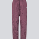 Tracksuitpants in purple in 100% recycled nylon. Volmermd pants have piping along the sideseam and cutline details for a sporty look.