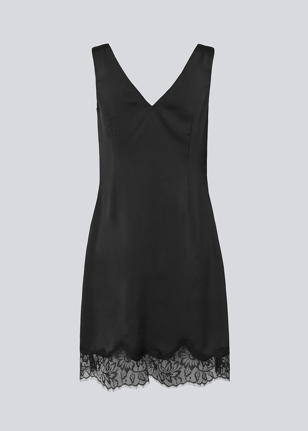 Short black satin dress with lace details. Vuemd dress features wide straps, a crossed detail lace at the bust, lace at the bottom, and a hidden side zip. Elegant and feminine – ideal for both everyday wear and special occasions.