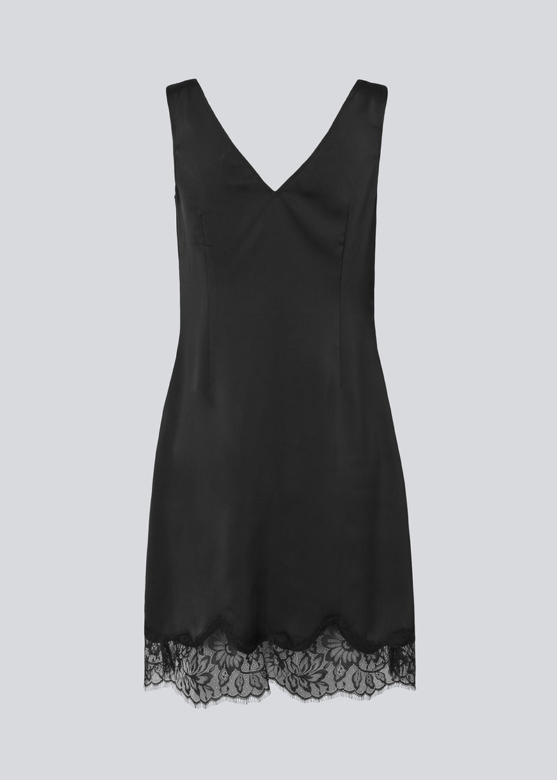 Short black satin dress with lace details. Vuemd dress features wide straps, a crossed detail lace at the bust, lace at the bottom, and a hidden side zip. Elegant and feminine – ideal for both everyday wear and special occasions.