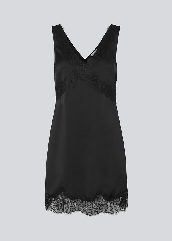 Short black satin dress with lace details. Vuemd dress features wide straps, a crossed detail lace at the bust, lace at the bottom, and a hidden side zip. Elegant and feminine – ideal for both everyday wear and special occasions.