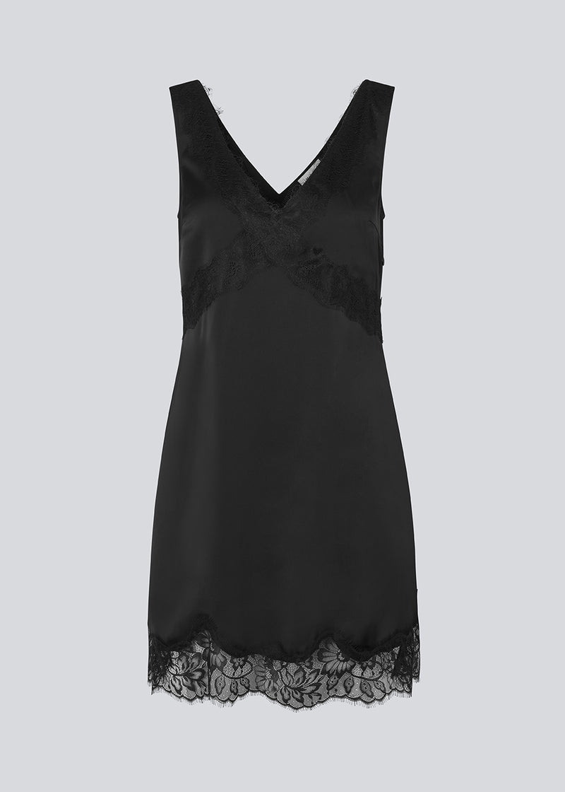 Short black satin dress with lace details. Vuemd dress features wide straps, a crossed detail lace at the bust, lace at the bottom, and a hidden side zip. Elegant and feminine – ideal for both everyday wear and special occasions.