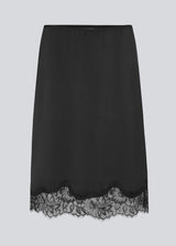 Elegant satin skirt in black with lace details on the bottom. Vuemd skirt is a knee-length satin style with an elastic waist and a relaxed fit. Perfect worn alone or layered for versatile styling.