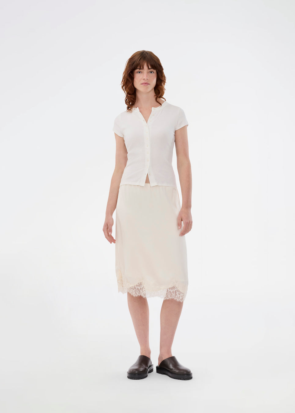 Elegant satin skirt in white/cream with lace details. VueMD skirt is a knee-length satin style with an elastic waist and a relaxed fit. Perfect worn alone or layered for versatile styling.&nbsp;