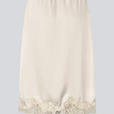 Elegant satin skirt in white/cream with lace details. VueMD skirt is a knee-length satin style with an elastic waist and a relaxed fit. Perfect worn alone or layered for versatile styling.&nbsp;