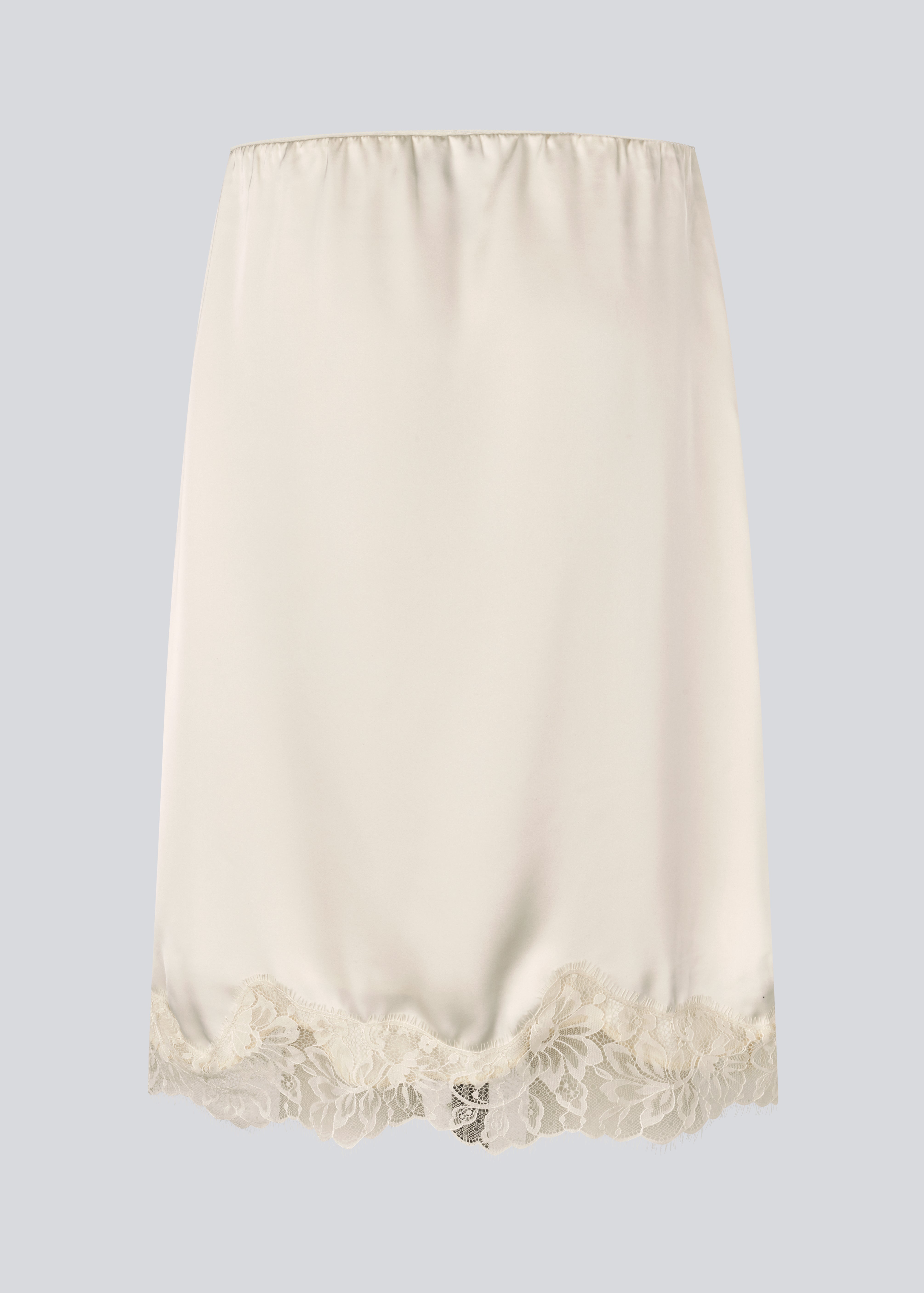 Elegant satin skirt in white/cream with lace details. VueMD skirt is a knee-length satin style with an elastic waist and a relaxed fit. Perfect worn alone or layered for versatile styling.&nbsp;