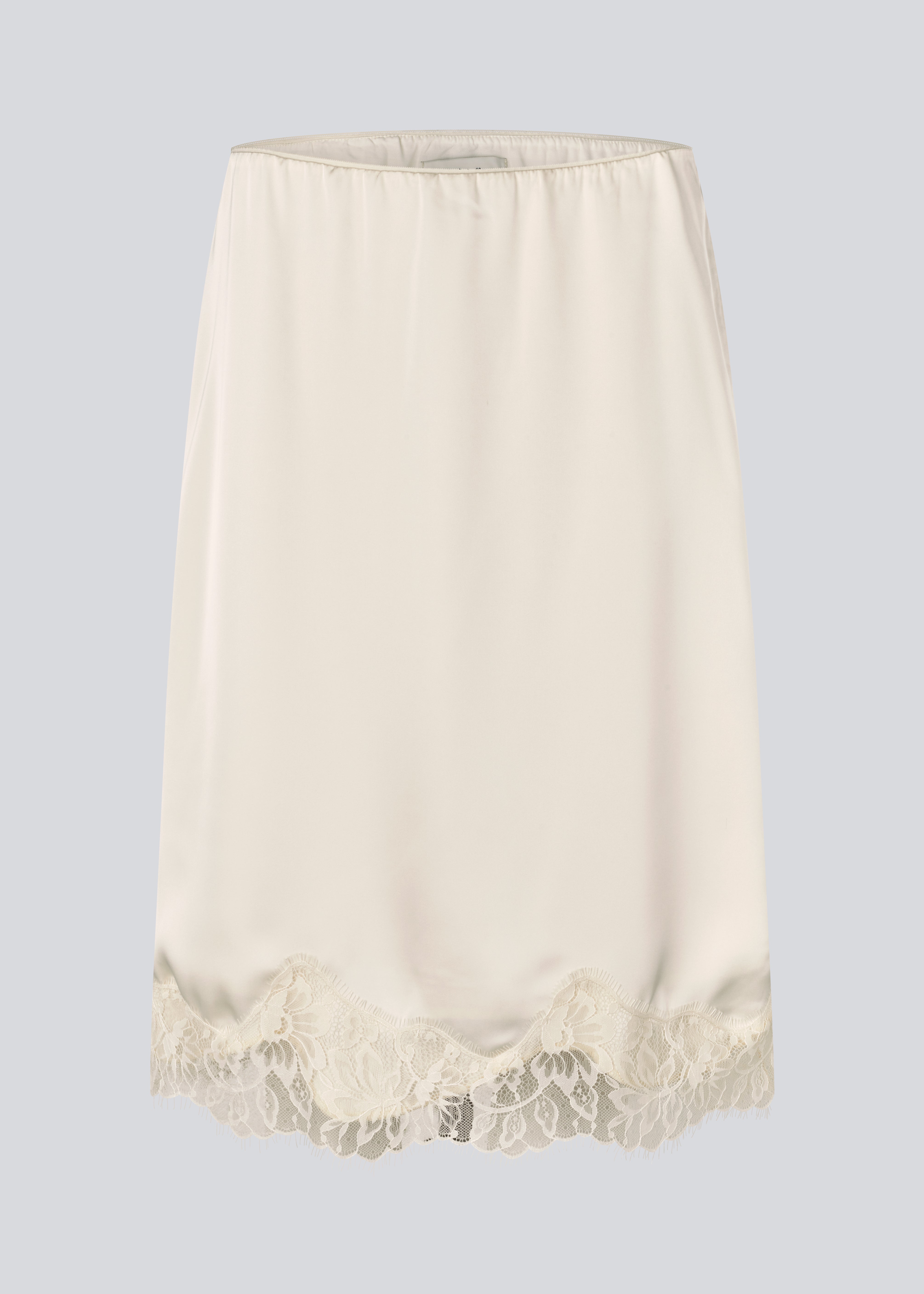 Elegant satin skirt in white/cream with lace details. VueMD skirt is a knee-length satin style with an elastic waist and a relaxed fit. Perfect worn alone or layered for versatile styling.&nbsp;
