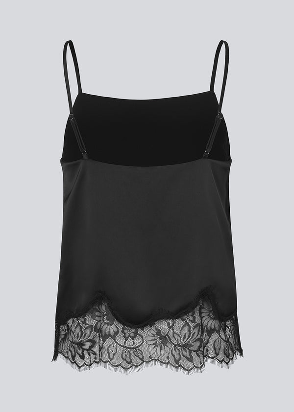 Delicate satin top in black with lace details on the bottom. Vuemd top has adjustable straps and refined lace details at the hem. Perfect worn alone or styled as part of a layered look.