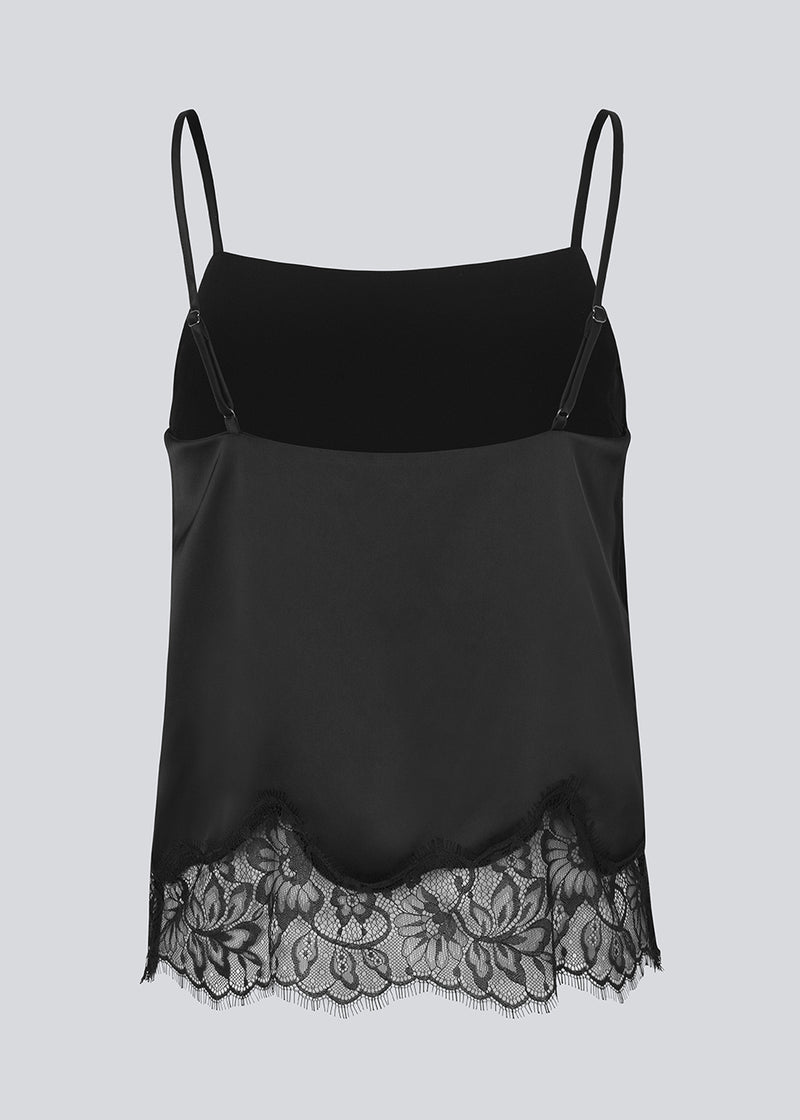 Delicate satin top in black with lace details on the bottom. Vuemd top has adjustable straps and refined lace details at the hem. Perfect worn alone or styled as part of a layered look.