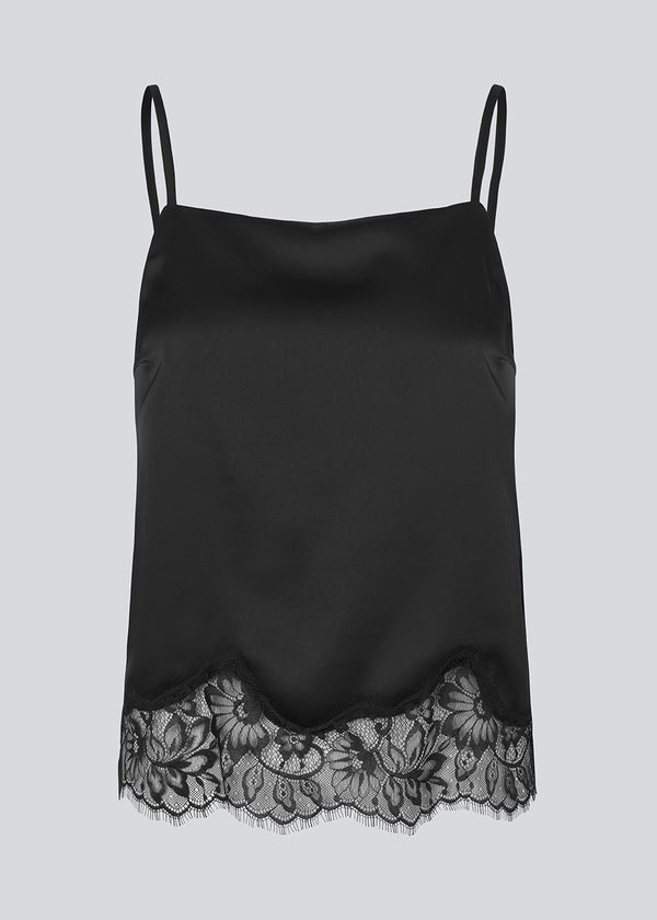 Delicate satin top in black with lace details on the bottom. Vuemd top has adjustable straps and refined lace details at the hem. Perfect worn alone or styled as part of a layered look.