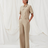 Jumpsuit in a crispy cotton blend with long, wide legs. DedeMD jumpsuit has short sleeves, collar, and zipper down the front. Belt straps at the waist. The model is 177 cm and wears a size S/36.