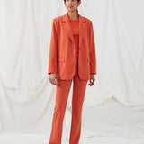 Pants in red with wide legs and a medium waist. AnkerMD pants have creases, button and zip fly, side pockets and paspel back pockets.  The model is 177 cm and wears a size S/36. Style the pants with a matching blazer in the same color: Gale blazer.