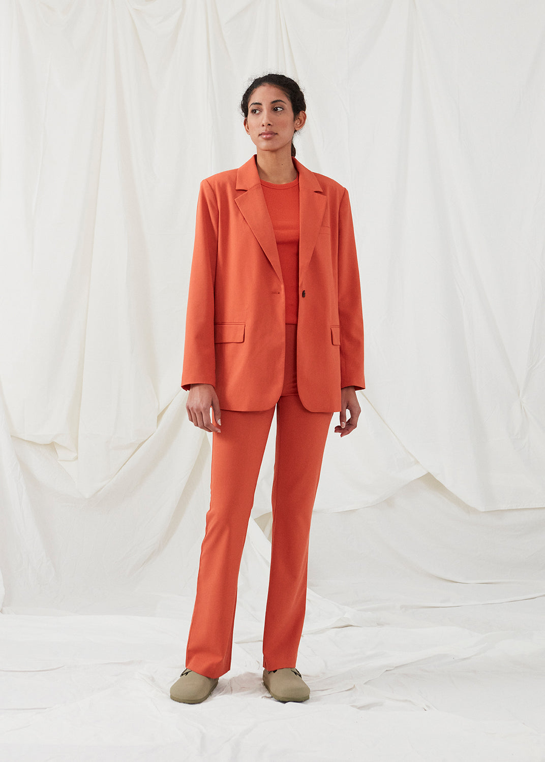 Pants in red with wide legs and a medium waist. AnkerMD pants have creases, button and zip fly, side pockets and paspel back pockets.  The model is 177 cm and wears a size S/36. Style the pants with a matching blazer in the same color: Gale blazer.