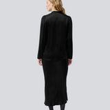 Black long wide satin skirt. Parveenmd skirt has an elastic waistband. The model is 175 cm and wears a size s/36.