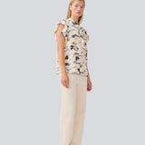 Sleeveless top with frill details. MistMD SS top has a loose fit and a button closure with frill details in front. 