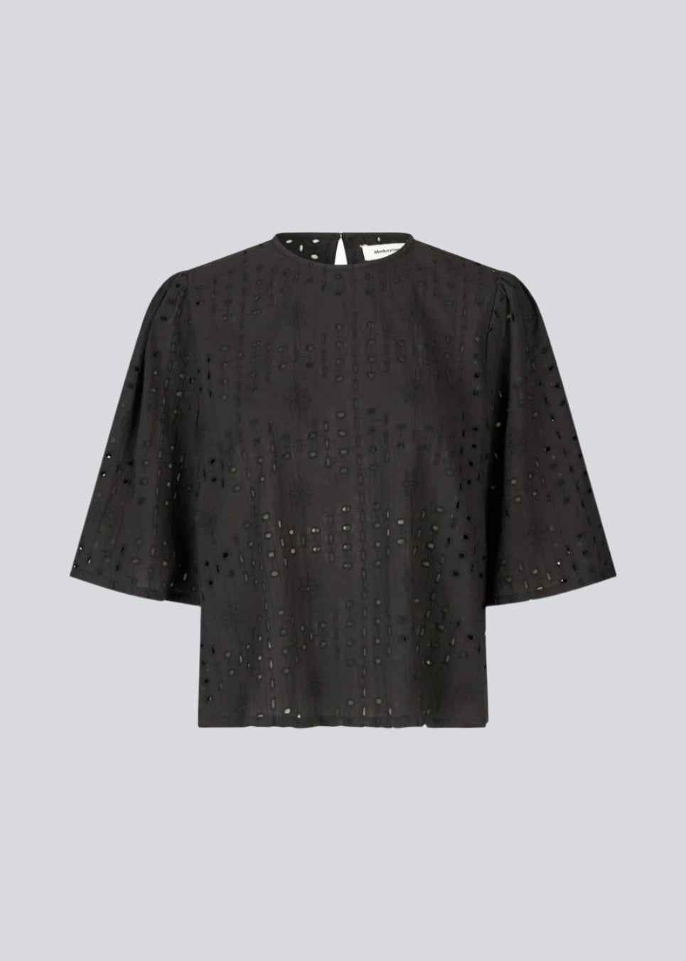 Top med korte ærmer i broderie anglaise. MisoMD top har en løs pasform og en slidsmed knappelukning i ryggen. 