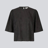 Top med korte ærmer i broderie anglaise. MisoMD top har en løs pasform og en slidsmed knappelukning i ryggen. 