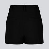 Black high-waisted shorts with side pockets. NormaMD shorts have a zip fly and button, belt loops, and decorative paspoil pockets on the back.