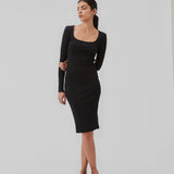 Rib knitted dress in black in a tight fit cotton quality. ToxieMD dress has a square neckline in front and long sleeves. The model is 177 cm and wears a size S/36.