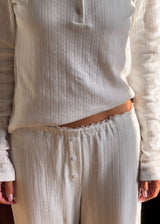 White pointelle pants. Josefinemd pants are feminine pointelle cotton trousers with lace trim and a subtle openwork pattern. Soft, comfortable, and ideal for relaxing at home. Josefine Vogt (165 cm) and the model (177 cm) are both wearing size Small.