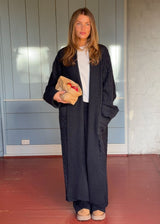 Blue cable-knit long cardigan. The Josefinemd robe is a long cardigan featuring pockets and a tie belt. Perfect for cozy mornings and chilly winter days.&nbsp;Josefine Vogt (165 cm) and the model (177 cm) are both wearing size Small.