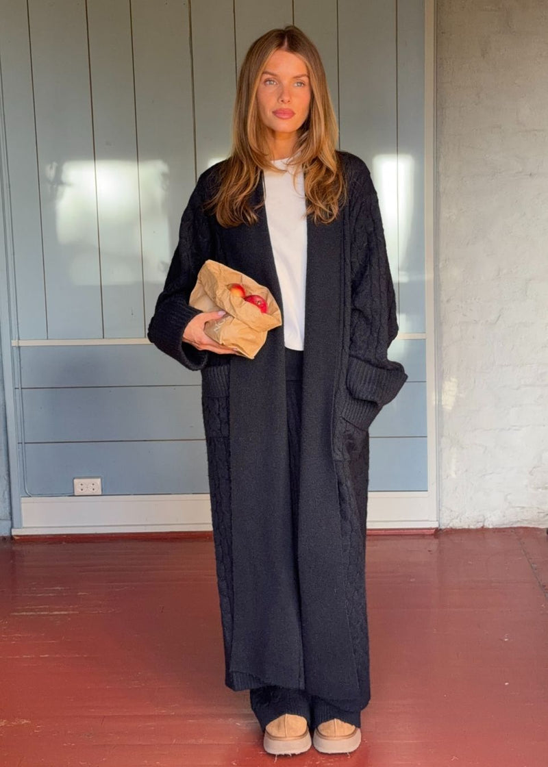 Blue cable-knit long cardigan. The Josefinemd robe is a long cardigan featuring pockets and a tie belt. Perfect for cozy mornings and chilly winter days.&nbsp;Josefine Vogt (165 cm) and the model (177 cm) are both wearing size Small.