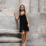 Short dress with a straight silhouette and wide straps. FazilMD dress has a see-through overlay with shiny pearls and a slip dress with a v-neckline. The model is 175 cm and wears a size S/36.